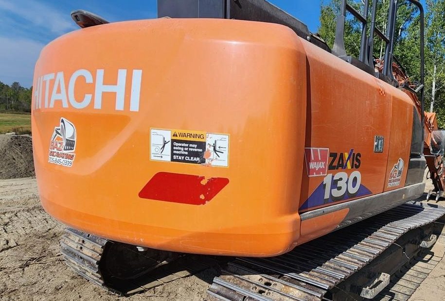 Hitachi ZX130 counterweight before detailing, oxidized chalky orange paint