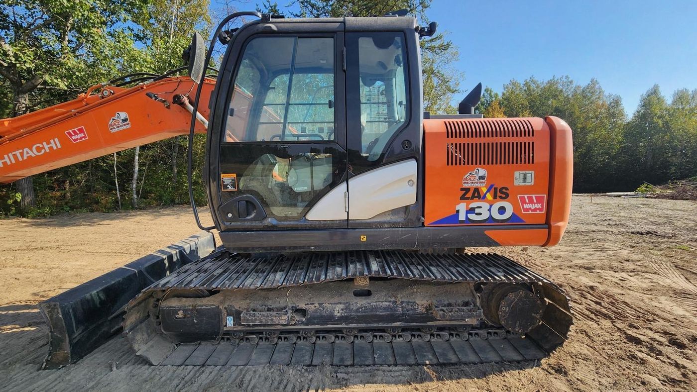 Hitachi ZX130 excavator before detailing, faded dusty orange